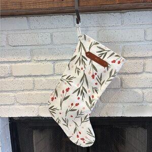 Festive Holiday Stocking with Red Berries and Green Leaves